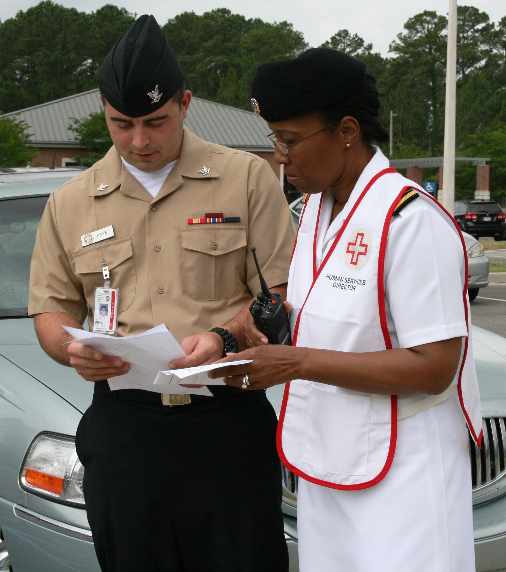 Naval Health Clinic Charleston Director for Staff Education and Training,
Lt. Cmdr. Yvette Smith-Simon, consults with Petty Officer 3rd Class Jimmy Frye to ensure all staff members have evacuated the clinic during an emergency drill in preparation for the Joint Commission and Navy Medical Inspector General inspections last week. (U.S. Navy photo/Jeff Kelly)
