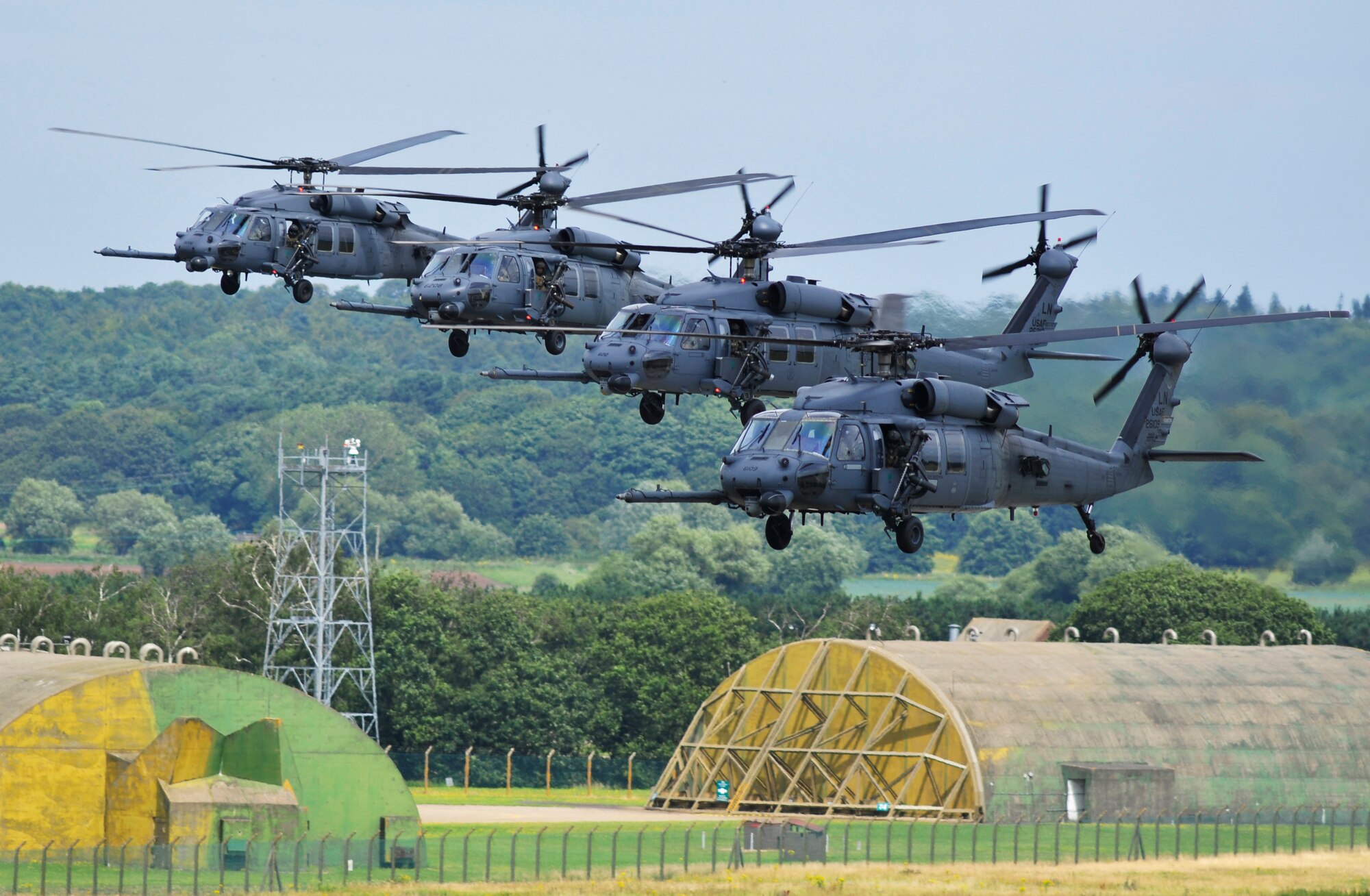 ROYAL AIR FORCE LAKENHEATH, England - A four-ship fleet of 56th Rescue Squadron HH-60G Pave Hawks fly past the air traffic control tower Aug. 13, 2012. This is the first time the 56th RQS has flown more than three helicopters at once since arriving at RAF Lakenheath in 2006. (U.S. Air Force photo by Senior Airman Tiffany M. Grigg)
