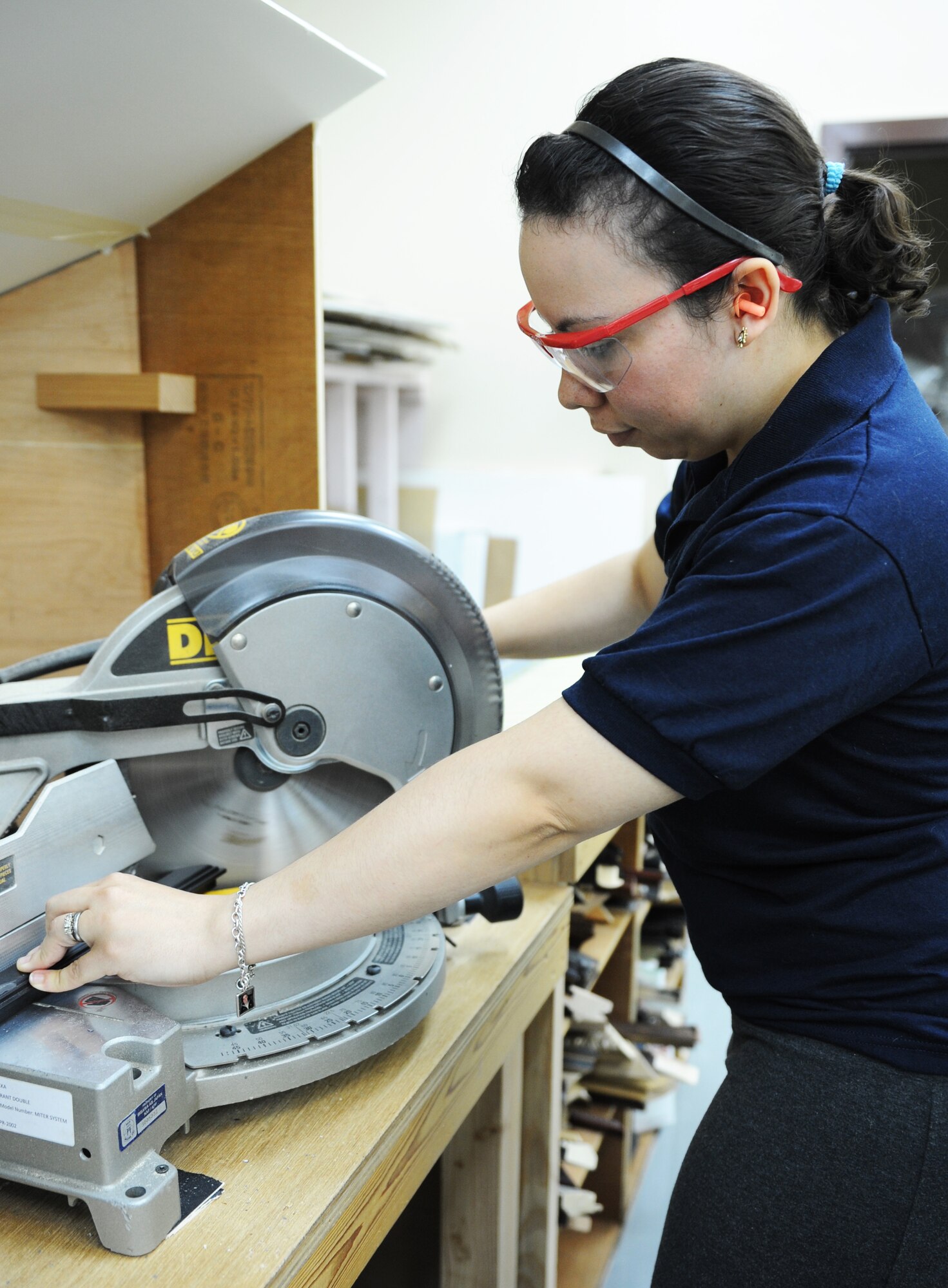 Adine Close, 35th Force Support Squadron recreation aide, cuts a frame in The Frame Shop at Misawa Air Base, Japan, Aug. 15, 2012. The Frame Shop offers many services, including custom mat and glass cuts, frame repairs, canvas stretching, basic framing classes, heat mounting, shadowboxes, photo printing and design guidance. (U.S. Air Force photo by Airman 1st Class Kia Atkins/Released)