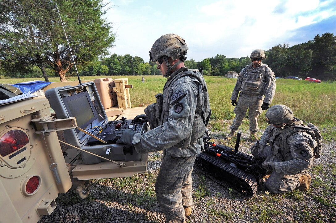 Army Staff Sgt. Frank Rodriguez, center, gives direction to Sgt. Matthew Eldridge, right, and Sgt. Jerred Keeton as they prep a robot used for ordnance disposal for a vehicle exercise during the first 20th Support Command's competition for Explosive Ordnance Disposal Team of the Year on Fort Knox, Ky., Aug. 14, 2012. Rodriguez, team leader, Eldridge and Keeton are assigned to the 22nd Chemical Battalion, Aberdeen Proving Ground, Md.