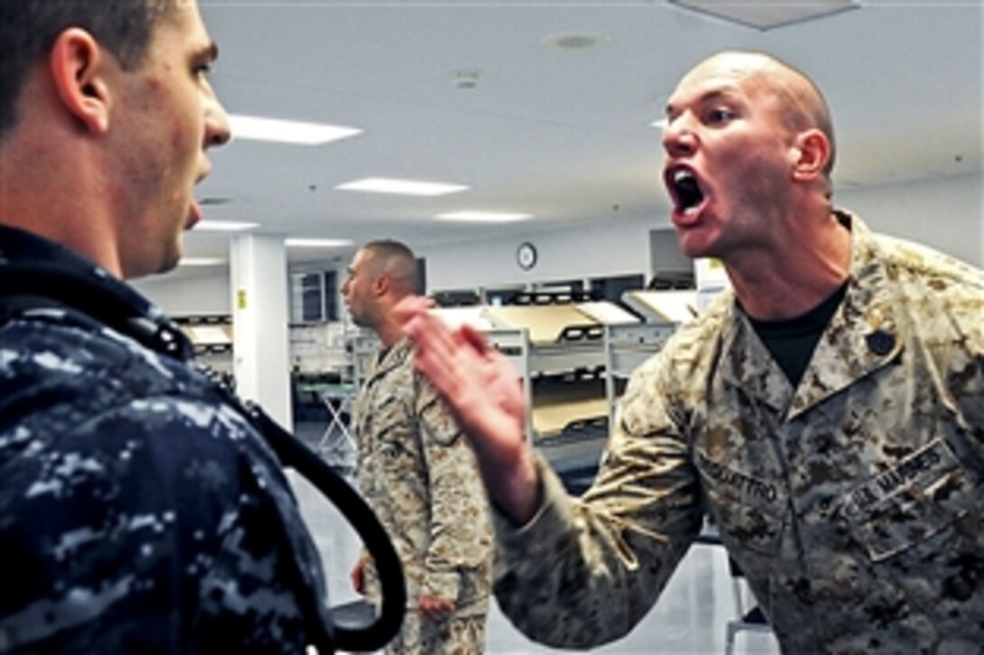 Marine Corps Gunnery Sgt. Michael DeQuattro instructs a midshipman on how to address a non-commissioned officer at Recruit Training Command, the Navy's only boot camp, on Naval Station Great Lakes, Ill., Aug. 9, 2012. Midshipmen from colleges and universities in the Chicago area attended annual orientation at the naval station. The eight-day orientation gives incoming Naval ROTC freshman a glimpse of Navy life and the type of training they will experience.