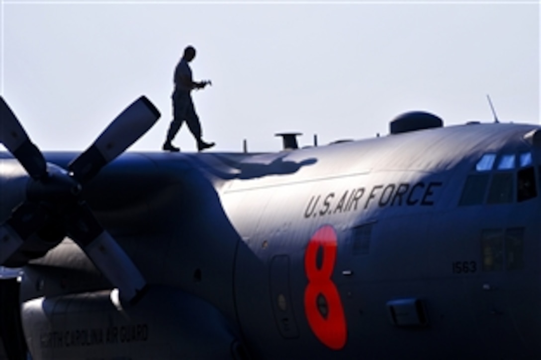 U.S. Air Force Master Sgt. Rodney Hall walks the wing of a C-130 Hercules aircraft equipped with a firefighting system during a preflight inspection in Charlotte, N.C., Aug. 13, 2012. The 145th Airlift Wing, North Carolina Air National Guard, sent two C-130 Hercules cargo planes to California, where they fought fires at the direction of the U.S. Forest Service. 