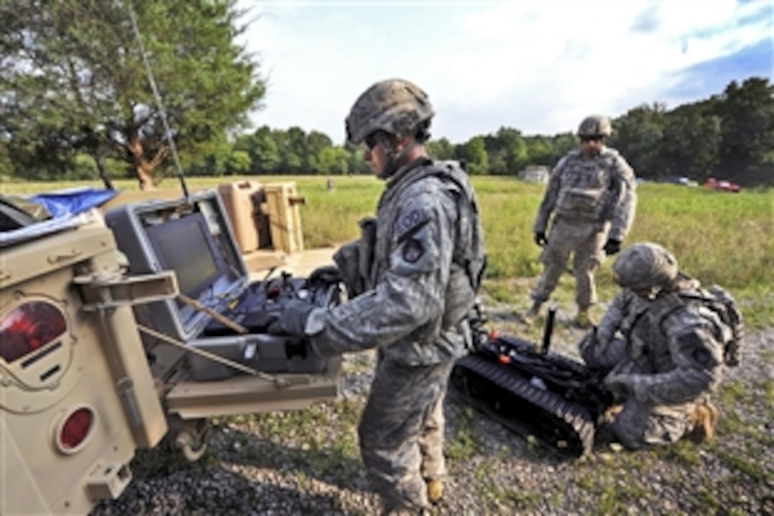 Army Staff Sgt. Frank Rodriguez, center, gives direction to Sgt. Matthew Eldridge, right, and Sgt. Jerred Keeton as they prep a robot used for ordnance disposal during the first 20th Support Command's competition for Explosive Ordnance Disposal Team of the Year on Fort Knox, Ky., Aug. 14, 2012. Rodriguez, team leader, Eldridge and Keeton are assigned to the 22nd Chemical Battalion, Aberdeen Proving Ground, Md.