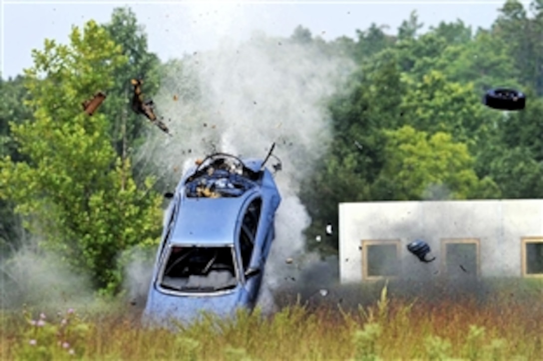 Soldiers trigger an explosive charge in a car during the first 20th Support Command's competition for Explosive Ordnance Disposal Team of the Year on Fort Knox, Ky., Aug. 14, 2012.