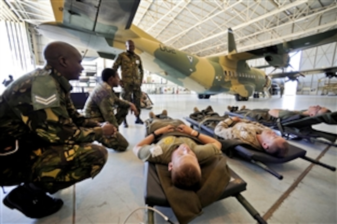 Members of the Botswana Defense Force prepare to load simulated casualties during Medlite 12 at Thebephatswa Air Base, Botswana, Aug. 14, 2012. U.S. Marine Corps reservists from the 4th Marine Division's Delta Company, Antiterrorism Battalion, served as the wounded troops following a mock ambush. During the exercise, Botswana medics watched U.S. trainers provide lifesaving care.
