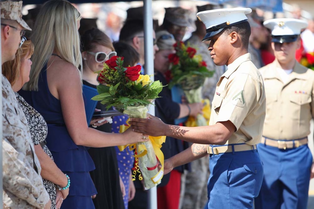 Marines give flowers to the family of Sgt. Matthew T. Abbate during his Navy Cross award ceremony aboard Camp Pendleton, Calif., Aug. 10. Abbate was posthumously awarded the medal for the actions he took on Oct. 14, 2010 in Sangin, Afghanistan during his deployment as a scout sniper with Company K, 3rd Battalion, 5th Marines, 1st Marine Division. Abbate was killed in action in Helmand Province later that year.