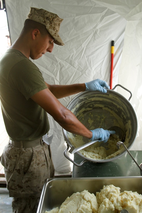 Lance Cpl. Joaquin Nuñez, a food service specialist with 3rd Battalion, 9th Marine Regiment, 2nd Marine Division and Chicago native, scoops mashed potatoes into a serving pan for the Field Mess Competition, August 3, 2012. 1/6 Food Service, with help from food service Marines with 3rd Battalion, 9th Marines represented  Division in a II Marine Expeditionary Force-wide field mess competition,  August 3, 2012 aboard Marine Corps Base Camp Lejeune. (U.S. Marine Corps photo by Sgt. Steve Cushman)