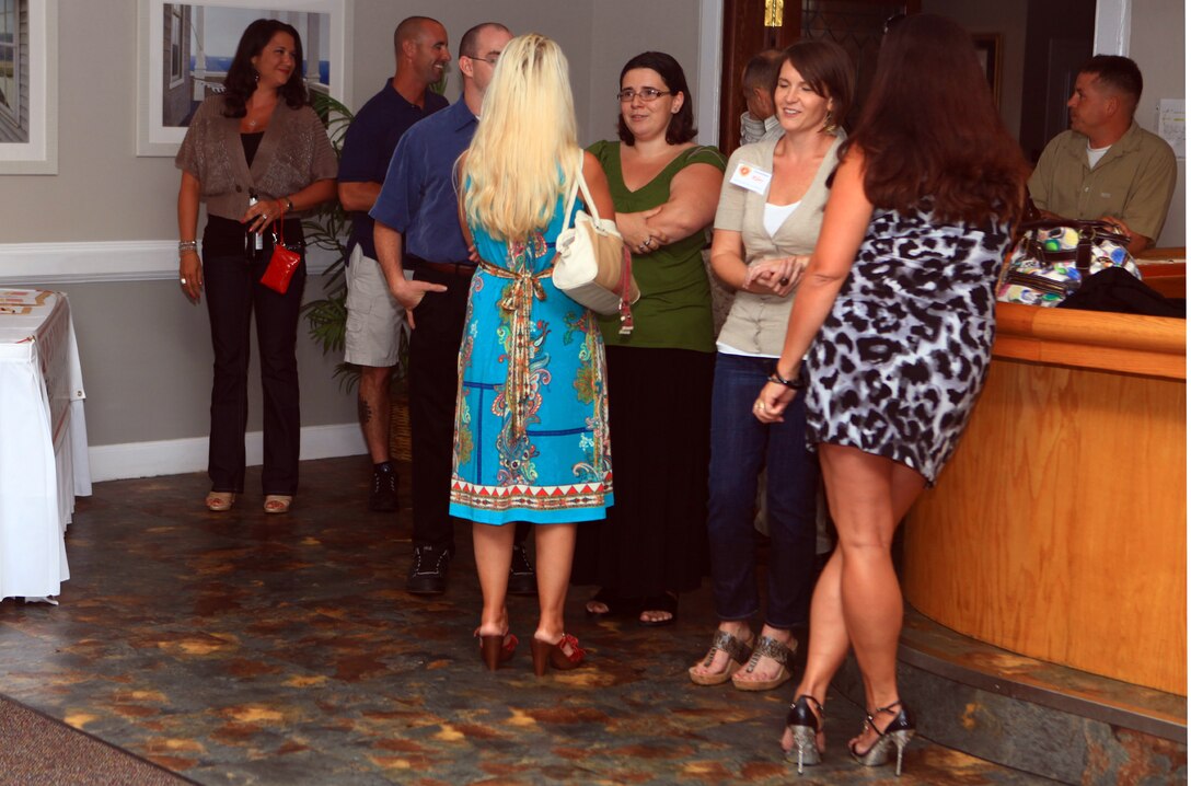 Spouses of servicemembers with Combat Logistics Regiment 27, 2nd Marine Logistics Group socialize at the beginning of the Spouse Appreciation Night at the Ball Center on Camp Lejeune, N.C., Aug. 10, 2012. The event included an award ceremony, music, food and leadership familiarization. 