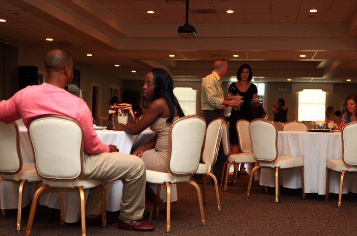 Master Sgt. Sebastian McNeill, the fiscal chief with Combat Logistics Regiment 27, 2nd Marine Logistics Group, and his wife, Jamelia, sit at a table during a Spouse Appreciation Night at the Ball Center on Camp Lejeune, N.C., Aug. 10, 2012.   McNeill has been in the Marine Corps 18 years, and has been married to his wife for 11 years.