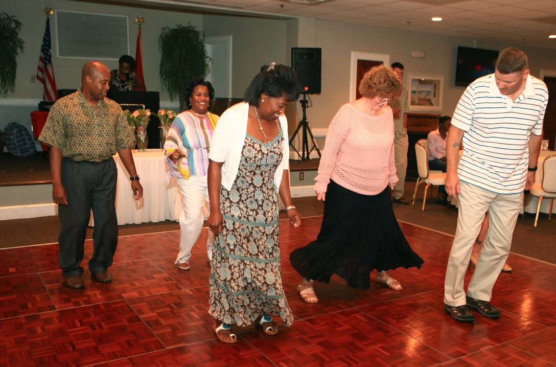 Couples dance during a Spouse Appreciation Night at the Ball Center at Camp Lejeune, N.C., Aug. 10, 2012.  Servicemembers with Combat Logistics Regiment 27, 2nd Marine Logistics Group brought their spouses to the event, which featured an award ceremony, food, music and door prizes. 