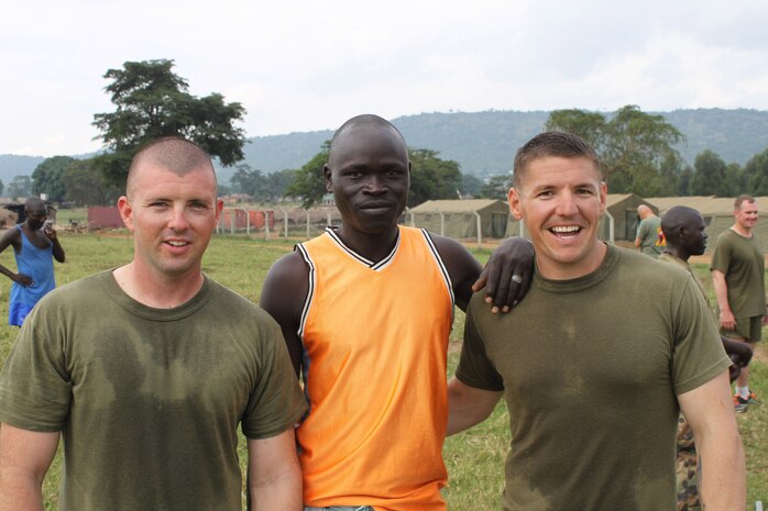 UGANDA - Cpl. Robert Winegar, left, a U.S. Marine assigned to Weapons Company, Battalion Landing Team 1st Battalion, 2nd Marine Regiment, 24th Marine Expedtionary Unit, and Sgt. William Tucker, right, a U.S. Marine with Special Purpose Marine Air Ground Task Force 12, pose for a picture with a member of the Ugandan military after finishing a physical training session together.  The Marines are in Uganda as members of a training team focused on training Ugandan forces in marksmanship, small unit tactics, and engineering.  The Ugandans are expecting to participate in the African Union Mission in Somalia.  (Photo provided by 1st Lt. Herman Davis)

are in Uganda assisting in training Ugandan forces for the African Union Mission in Somalia, called AMISOM for short.