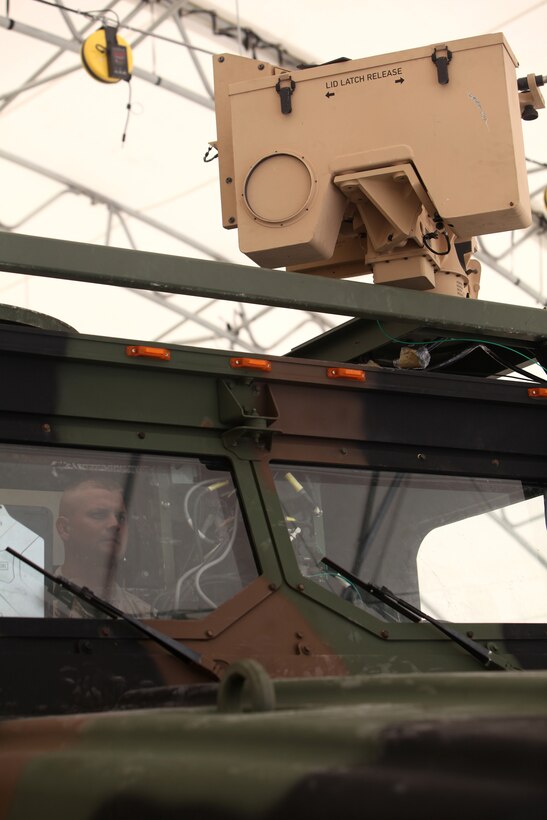Sgt. Matthew T. Phillips (inside cab), a motor vehicle operator with Combat Logistics Regiment 2, 2nd Marine Logistics Group, operates a Gunslinger Package for Advanced Convoy Security system aboard Camp Lejeune, N.C., Aug. 15, 2012.  The GPACS system provides easy communication between machine gunners, better weapon control and can be mounted on a Medium Tactical Vehicle Replacement. The system is equipped with night vision and thermal capabilities, and is designed to carry the M249 light machine gun, M240 medium machine gun, or Mark II .50 caliber machine gun. 