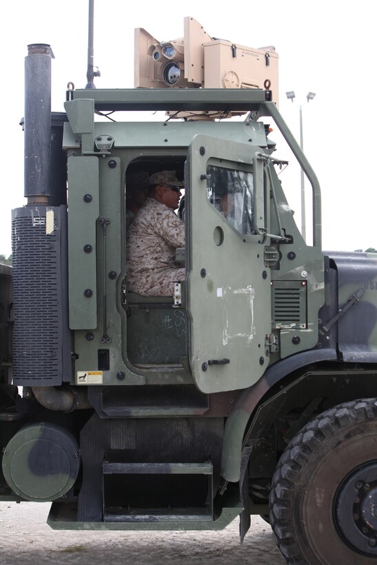 Sgt. Emerson C. Mason (inside cab), a motor vehicle operator with Combat Logistics Regiment 2, 2nd Marine Logistics Group, operates a Gunslinger Package for Advanced Convoy Security system aboard Camp Lejeune, N.C., Aug. 15, 2012.  The GPACS system provides easy communication between machine gunners, better weapon control and can be mounted on a Medium Tactical Vehicle Replacement. The system is equipped with night vision and thermal capabilities, and is designed to carry the M249 light machine gun, M240 medium machine gun, or Mark II .50 caliber machine gun.