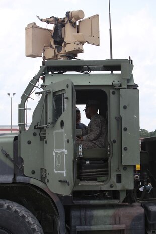 Two Marines with Combat Logistics Regiment 2, 2nd Marine Logistics Group operate a Gunslinger Package for Advanced Convoy Security system aboard Camp Lejeune, N.C., Aug. 15, 2012.  Fifty troops with CLR-2 participated in a two-week course where they learned how to effectively operate the system.  The GPACS system provides easy communication between machine gunners, better weapon control and can be mounted on a Medium Tactical Vehicle Replacement. The system is equipped with night vision and thermal capabilities, and is designed to carry the M249 light machine gun, M240 medium machine gun, or Mark II .50 caliber machine gun.