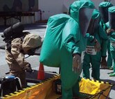Marines conduct decontamination training during a chemical, biological,radiological and nuclear hazardous material response drill at Camp Kinser Aug. 10. The purpose of the training was to ensure Marines maintain military occupational proficiency when dealing with hazardous material. The Marines evacuated simulated casualties and completed the scenario perfectly, according to Cpl. Jonathan M. Cane, a CBRN defense specialist. Cane and the Marines are with Combat Logistics Regiment 37, 3rd Marine Logistics Group, III Marine Expeditionary Force.