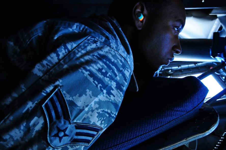 ANDERSEN AIR FORCE BASE, Guam – Senior Airman Andrew Belle, 36th Communications Squadron communication security accountant, gazes down the boom of a KC-135 Stratotanker during the island tour part of an incentive flight here, Aug. 10.  The island tour is a perk for the passengers that depend on the weather and the Airmen’s compliance to rules and procedures. (U.S. Air Force photo by Airman 1st Class Marianique Santos/Released)