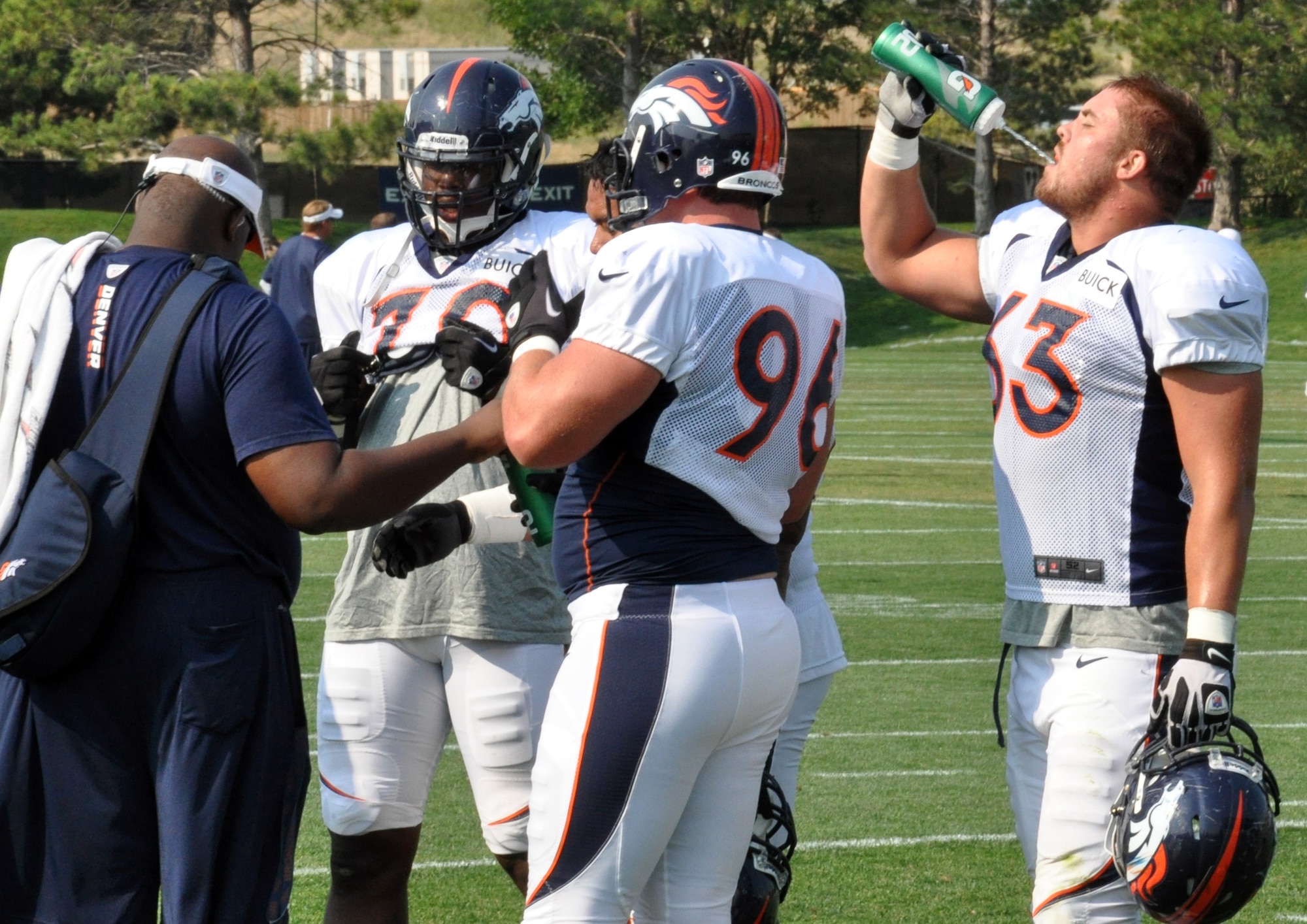 ENGLEWOOD, Colo. – Benjamin Garland, far right, Denver Broncos defensive end, takes a water break during a training camp session Aug. 14, 2012 at the Broncos training facility. Garland said learning a new defense, under new coordinator Jack Del Rio, has been the most challenging aspect of training camp. Garland said he will be expected to know the ins and outs of everybody’s assignment and where he needs to line up and where he needs to go when the ball snaps. (U.S. Air Force photo by Staff Sgt. Nicholas Rau)