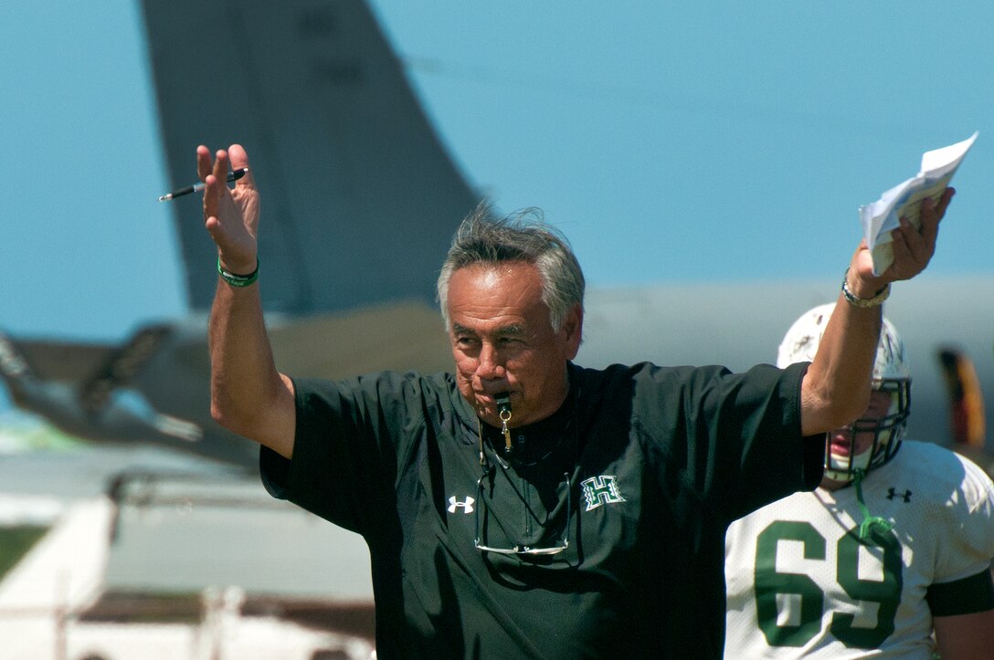 University of Hawaii head football coach Norm Chow directs the Warriors practice at Joint Base Pearl Harbor-Hickam Aug. 13. Due to the UH dormitories being cleaned and prepared for the start of the fall season, the Warriors had to seek accommodations elsewhere to continue their training camp. The UH football team is scheduled to be on the road for their opener Sept. 1, in Los Angeles, against the University of Southern California Trojans. (U.S. Air Force photo/Staff Sgt. Mike Meares)