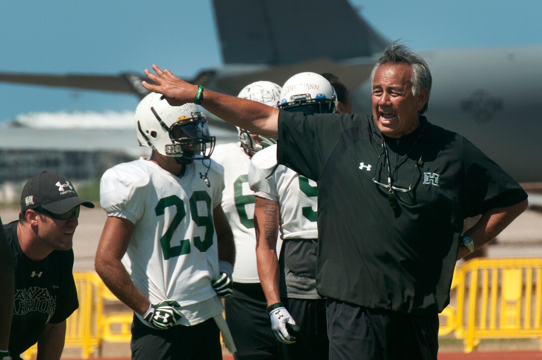 University of Hawaii head football coach Norm Chow directs the Warriors practice at Joint Base Pearl Harbor-Hickam Aug. 13. Due to the UH dormitories being cleaned and prepared for the start of the fall season, the Warriors had to seek accommodations elsewhere to continue their training camp. The UH football team is scheduled to be on the road for their opener Sept. 1, in Los Angeles, against the University of Southern California Trojans. (U.S. Air Force photo/Staff Sgt. Mike Meares)