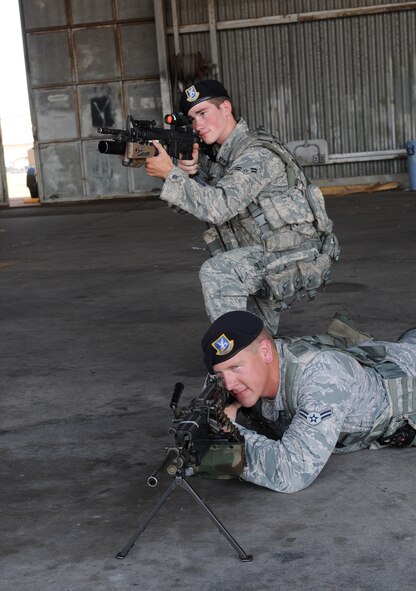 Airmen 1st Class Stephen Horton, above, and Matthew Sebey, 2nd Security Forces Squadron, aim their weapons during a simulated incident on the flightline on Barksdale Air Force Base, La., Aug. 10. Airmen from the 2 SFS carry a variety of weapons when patrolling the flightline to ensure base resources are properly protected. (U.S. Air Force photo/Airman 1st Class Benjamin Gonsier)(RELEASED)