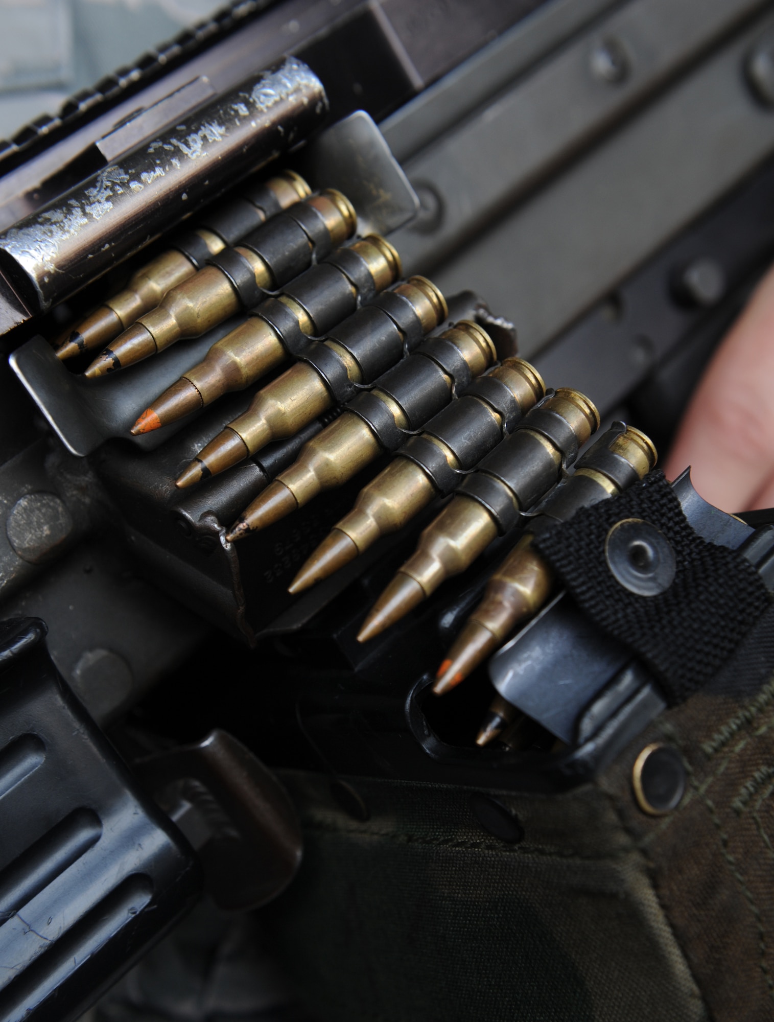 Airman 1st Class Matthew Sebey, 2nd Security Forces Squadron patrolman, holds a M249 light machine gun on Barksdale Air Force Base, La., Aug. 10. One out of every five consecutive rounds will have a yellow tipped tracer bullet, which ignites when fired and allows the trajectory of the round to be seen by the naked eye. When used at night, tracer rounds help Airmen see where their bullets are going to ensure accuracy. (U.S. Air Force photo/Airman 1st Class Benjamin Gonsier)(RELEASED)