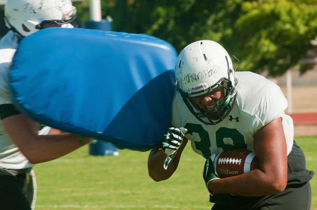 Ethan Watanabe, University of Hawaii freshman fullback, runs drills during the Warriors practice at Joint Base Pearl Harbor-Hickam Aug. 13. Due to the UH dormitories being cleaned and prepared for the start of the fall season, the Warriors had to seek accommodations elsewhere to continue their training camp. The UH football team is scheduled to be on the road for their opener Sept.  1, in Los Angeles, against the University of Southern California Trojans. (U.S. Air Force photo/Staff Sgt. Mike Meares)