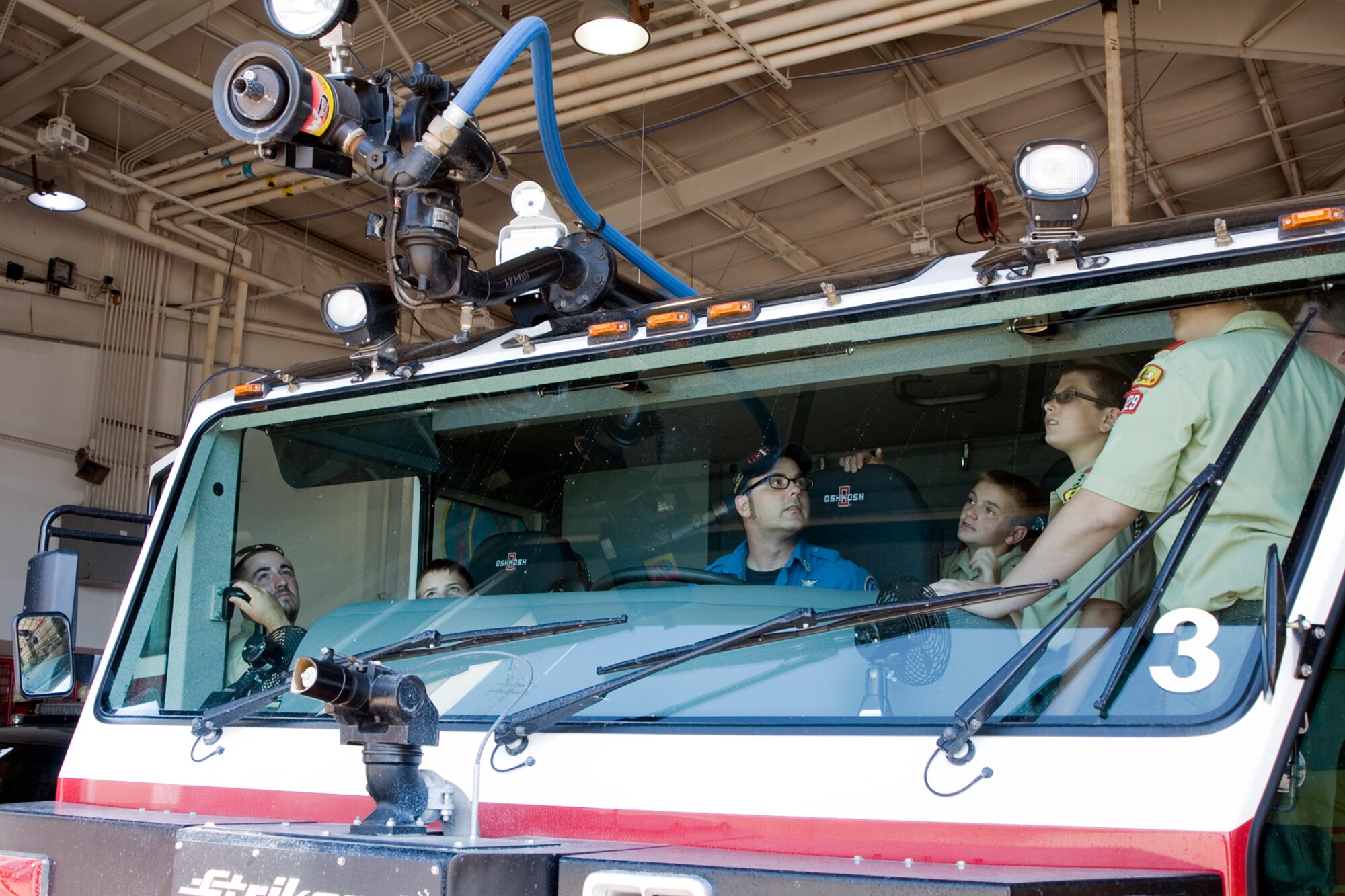 GRISSOM AIR RESERVE BASE, Ind. -- Christopher Pribbernow, Grissom Fire Department firefighter, shows Boy Scouts from Troop 229 how a water cannon on top of a Striker 1500 airport firefighting truck works during a base tour July 25. The Boy Scouts also saw a KC-135R Stratotanker on display and visited the 434th Operations Support Squadron to learn about the diverse jobs performed on base. (U.S. Air Force photo/Senior Airman Andrew McLaughlin)
