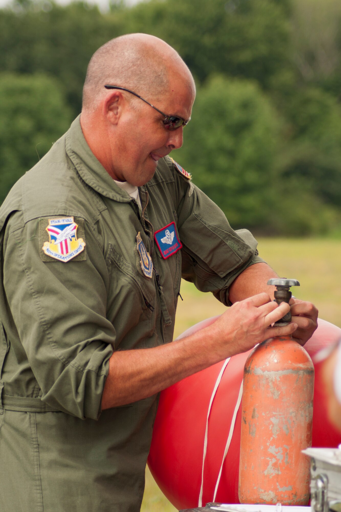 RAVENNA, Ohio -- U.S. Air Force Reserve Senior Master Sgt. Bryan Watson, a loadmaster with the 910th Operations Group based at Youngstown Air Reserve Station, uses special equipment to test wind speeds at the Camp Ravenna Joint Military Training Center here, Aug. 14, 2012 while performing ground checks prior to the 2012 Media Flight cargo airdrop. Nine members of the Youngstown-area media flew aboard a C-130H Hercules aircraft and experienced 910th Airlift Wing mission first-hand. U.S. Air Force photo by Tech. Sgt. Brenda Haines/Released