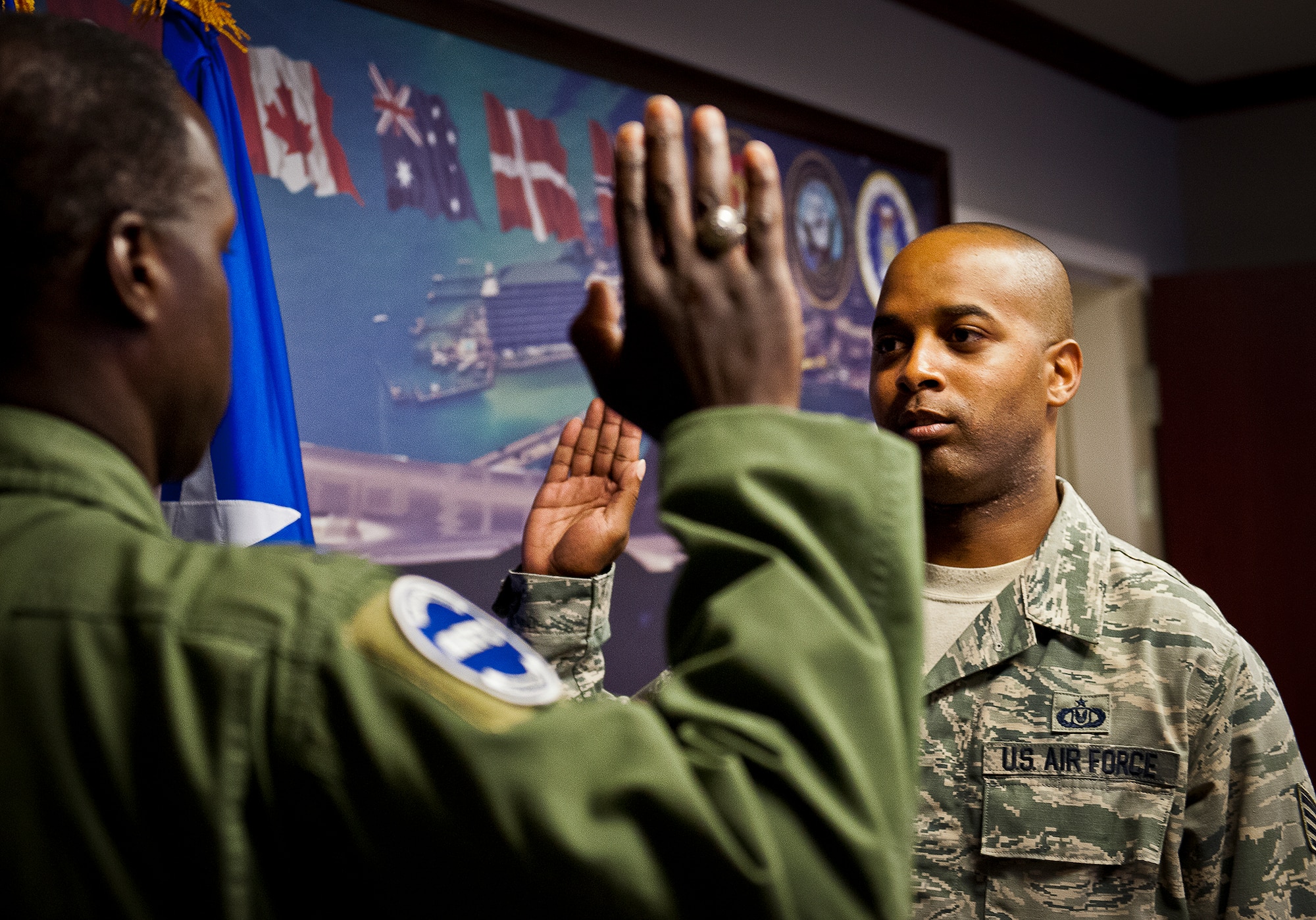 Staff Sgt. Christopher Tate, of the 33rd Maintenance Squadron, receives the oath of enlistment Gen. Edward Rice, the Air Education and Training Command commander, Aug. 15 at Eglin Air Force Base, Fla.  Tate reenlisted in the Air Force for six more years.  Rice reenlisted Tate while on his second site visit to the 33rd Fighter Wing.  (U.S. Air Force photo/Samuel King Jr.)