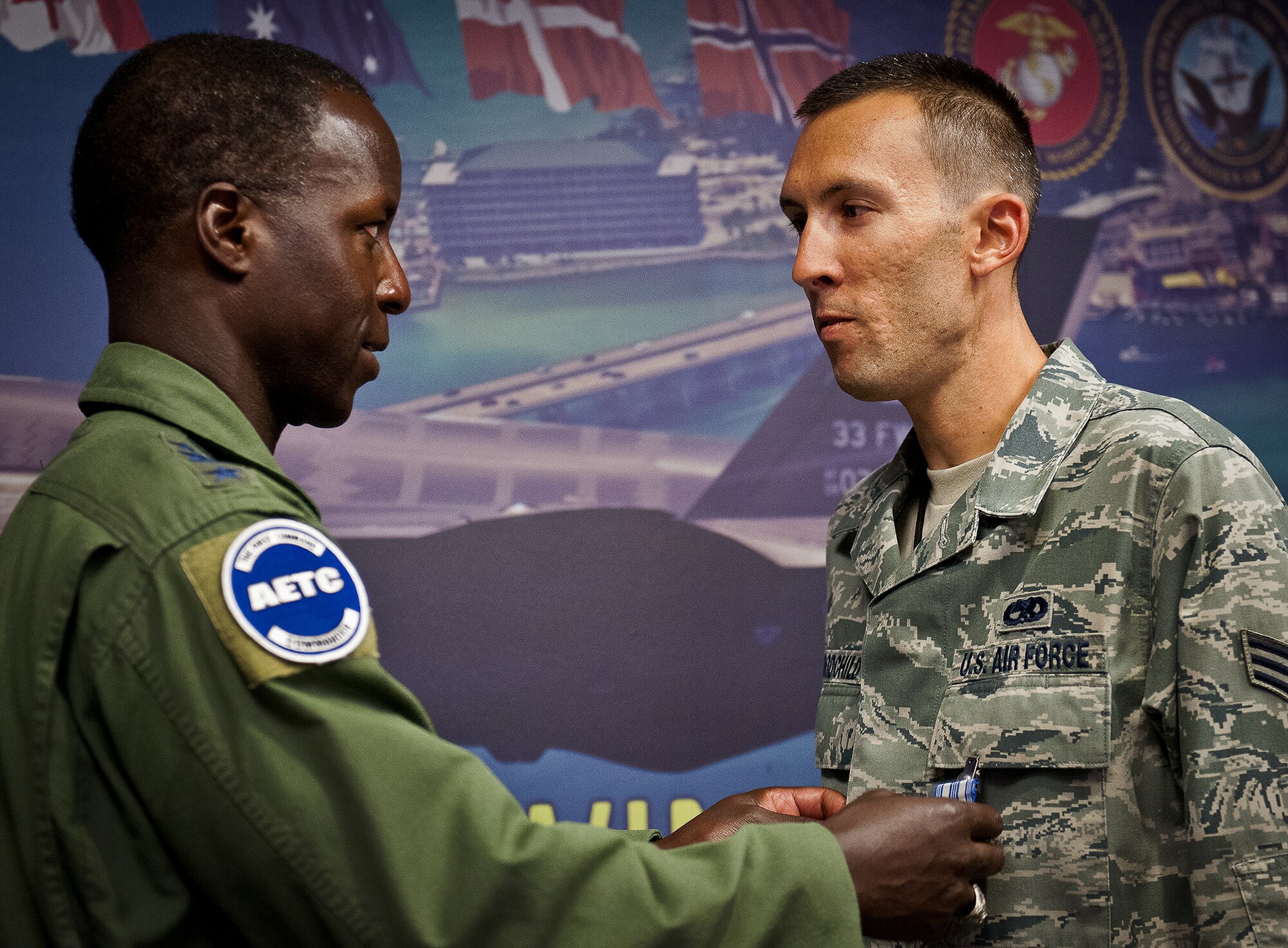 Senior Airman Andrew Goodchild, of the 33rd Maintenance Squadron, receives an Air Force Achievement Medal from Gen. Edward Rice, the Air Education and Training Command commander, for his quick response and help during a medical emergency, Aug. 15 at Eglin Air Force Base, Fla.  Goodchild used his self-aid and buddy care training to help someone who was displaying signs of shock and called 911 to get her the proper medical attention.  (U.S. Air Force photo/Samuel King Jr.)