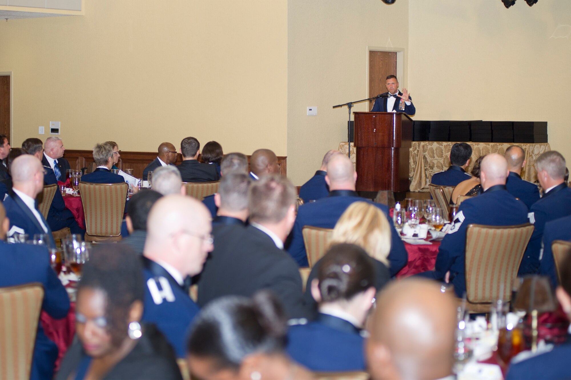 Chief Master Sgt. Deno Mackin, 2nd Air Force command chief, gives a keynote speech at the Senior NCO induction ceremony Aug. 10, 2012, at the Bay Breeze Event Center, Keesler Air Force Base, Miss. Fifty Keesler master sergeant selects were officially welcomed into the senior NCO enlisted tier at the event. (U.S. Air Force photo by Adam Bond)