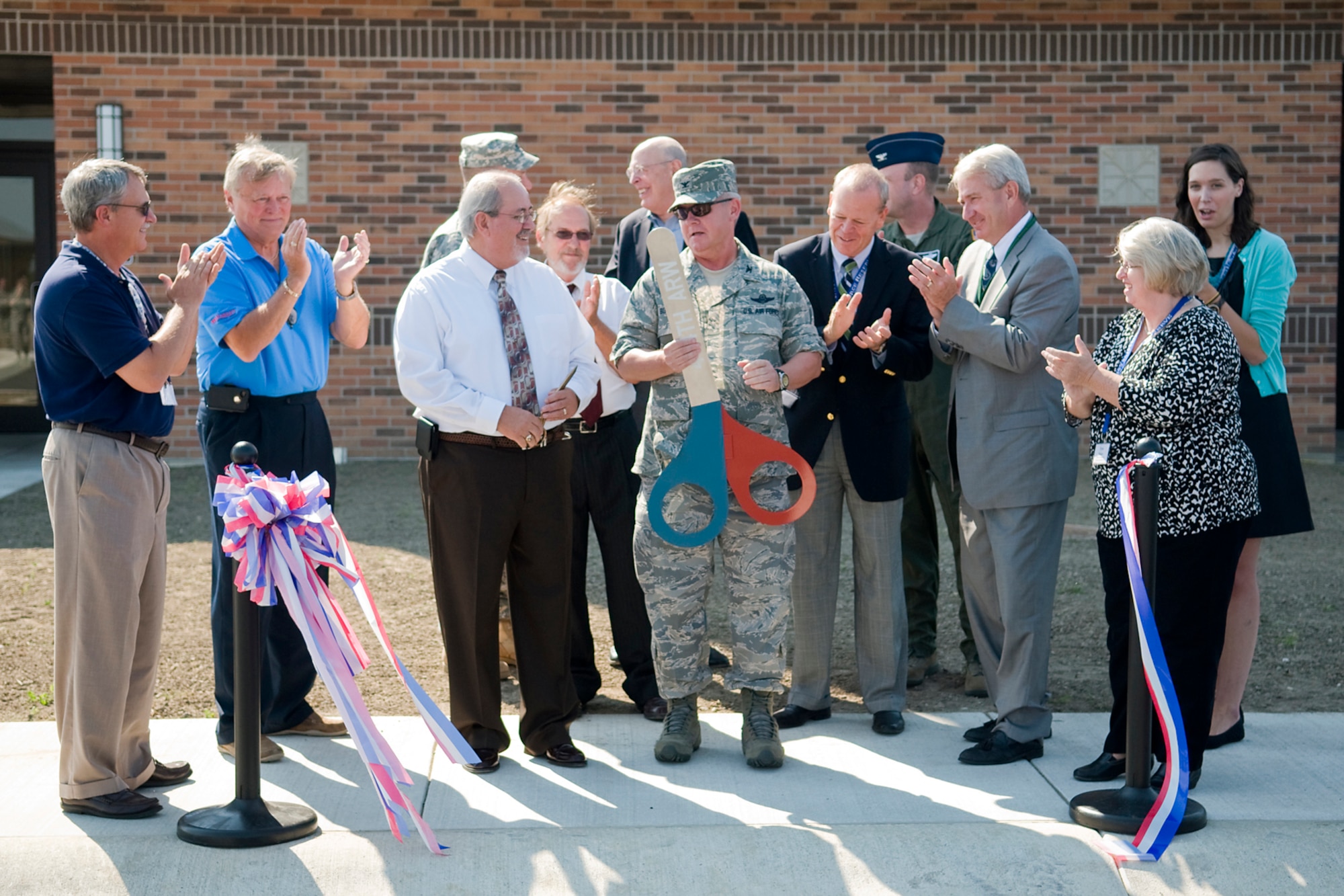 GRISSOM AIR RESERVE BASE, Ind. -- Grissom leadership, construction personnel, elected officials and representatives all applaud after a ribbon is cut opening Grissom's new $7.4 million air traffic control tower here Aug. 3. Grissom controls all military, civilian and commercial aviation up to 10,000 feet between Chicago Center and Indianapolis Center, going as far West as Lafayette, Ind. (U.S. Air Force photo/Tech. Sgt. Mark R. W. Orders-Woempner)