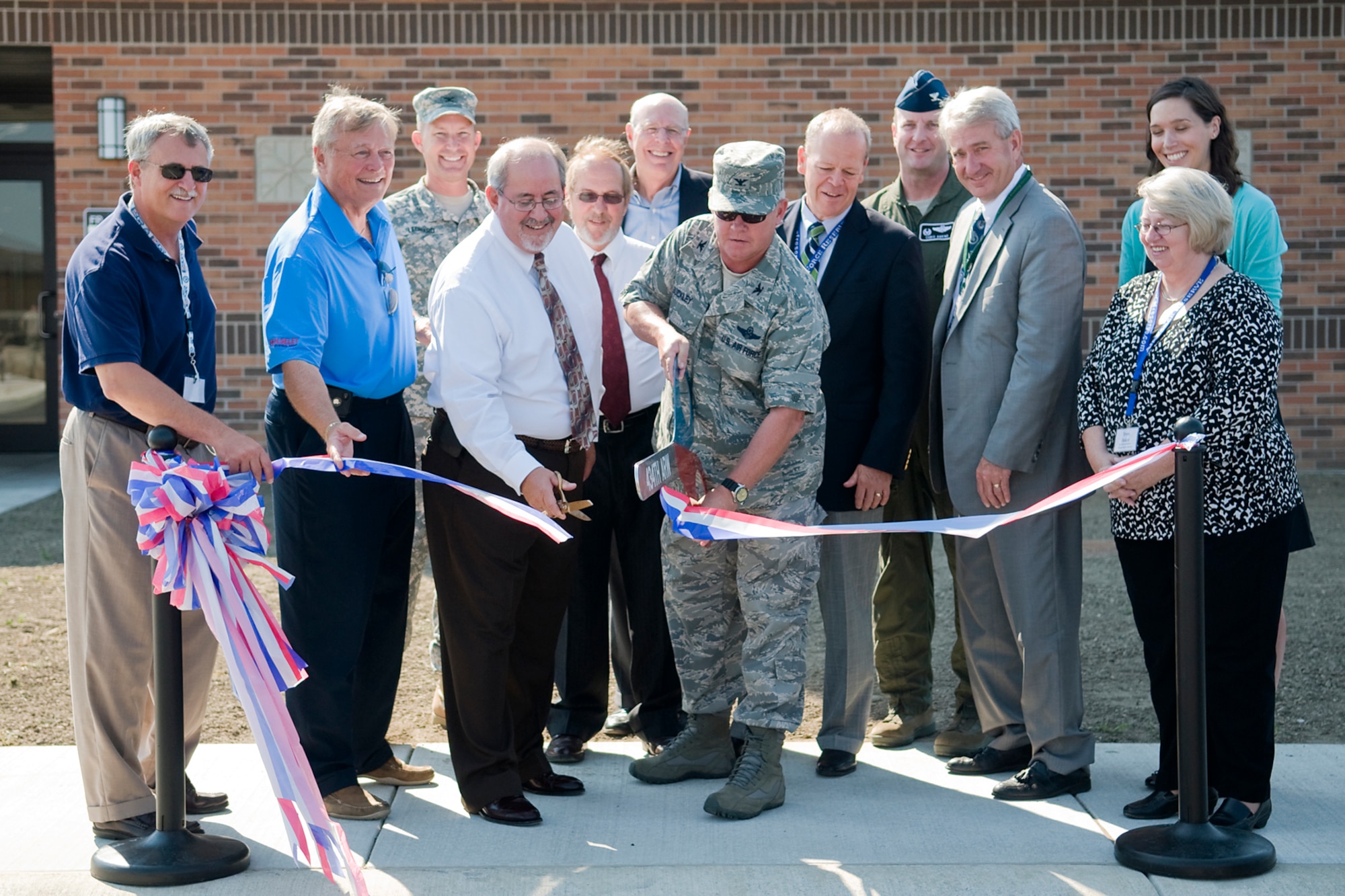 GRISSOM AIR RESERVE BASE, Ind. -- Grissom leadership, elected officials and representatives, and construction personnel cut a ribbon opening a new $7.4 million air traffic control tower here Aug. 3. Pictured from left are Mike Karickhoff, Indiana state representative; Tom Weatherwax, Grissom Community Council president; Col. Luke Leonard, U.S. Army Corps of Engineers Lousiville District commander; Bob Ulibarri, 434th Operations Support Squadron airfield operations manager; Terry Albaugh, 434th OSS air traffic manager; William Butt, owner of a construction company; Col. Don Buckley, 434th Air Refueling Wing commander; David Murtaugh, northwest Indiana region director for U.S. Sen. Dan Coats;  Col. Christopher Amend, 434th Operations Group commander; Jim Walker, mayor of Peru, Ind.; Tresa Baker, special assistant to U.S. Rep. Dan Burton; and Meredith Perks, case manager for U.S. Rep. Joe Donnelly. (U.S. Air Force photo/Tech. Sgt. Mark R. W. Orders-Woempner)
