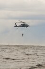 An HH-60 Pave Hawk with the 41st Rescue Squadron, Moody Air Force Base, Ga., hoists up two pararescuemen during water training in the Gulf of Mexico, Aug. 14, 2012. The Pave Hawk has multiple ways to retrieve personnel from the ground. The training allowed members to train on how to retrieve personnel located in open waters. (U.S. Air Force photo by Staff Sgt. Joshua J. Garcia/Released)