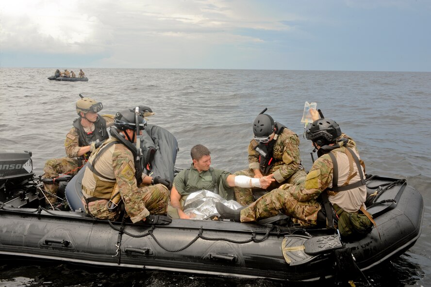 A pararescueman team from the 38th Rescue Squadron, Moody Air Force Base, Ga., apply self aid buddy care to Senior Airman Rudy Parsons, 38th RQS, during a water rescue exercise in the Gulf of Mexico, Aug. 14, 2012. The team applied an I.V. to Parsons in choppy water conditions to ensure the training was as realistic as can possible. (U.S. Air Force photo by Staff Sgt. Joshua J. Garcia/Released)