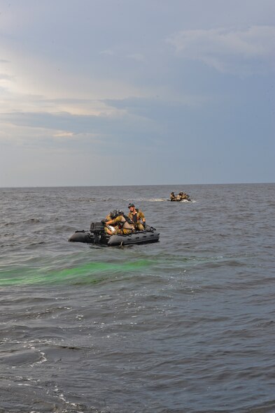 Two 38th Rescue Squadron pararescue teams, from Moody Air Force Base, Ga., apply self aid buddy care to two downed pilots during a water rescue exercise in the Gulf of Mexico, Aug. 14, 2012. The exercise trained members of the 347th Rescue Group how to locate and recover downed personnel in the open seas. (U.S. Air Force photo by Staff Sgt. Joshua J. Garcia/Released)