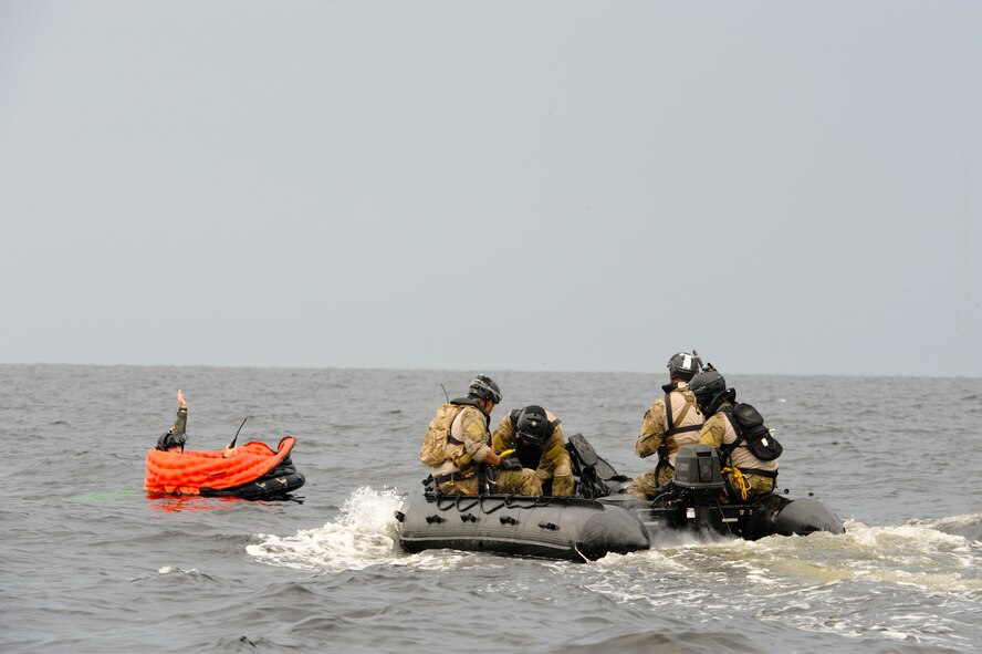 A team of pararescuemen from the 38th Rescue Squadron, Moody Air Force Base, Ga., approach Airman 1st Class Taras Ivaniuk, 38th RQS, who played the role of a downed pilot during a water rescue exercise in the Gulf of Mexico, Aug. 14, 2012. The exercise tested the members’ abilities to locate and rescue downed personnel in open water. (U.S. Air Force photo by Staff Sgt. Joshua J. Garcia/Released)
