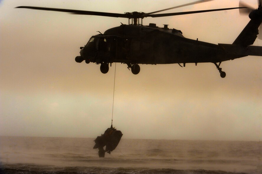 A Zodiac F470 watercraft is deployed from an HH-60 Pave Hawk from the 41st Rescue Squadron at Moody Air Force Base, Ga., during water rescue training in the Gulf of Mexico. The Zodiac F470 can be inflated in less than five minutes. The training allowed Airmen of the 347th Rescue Group to train rescuing downed personnel in open water. (U.S. Air Force photo by Staff Sgt. Joshua J. Garcia/Released)