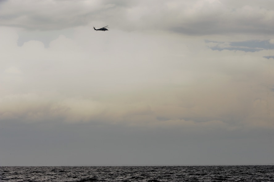 An HH-60 Pave Hawk from the 41st Rescue Squadron at Moody Air Force Base, Ga., searches the Gulf of Mexico for downed personnel during a water rescue exercise Aug. 14, 2012. Airmen from both the 41st RQS and 38th RQS worked to locate and rescue downed personnel. (U.S. Air Force photo by Staff Sgt. Joshua J. Garcia/Released)