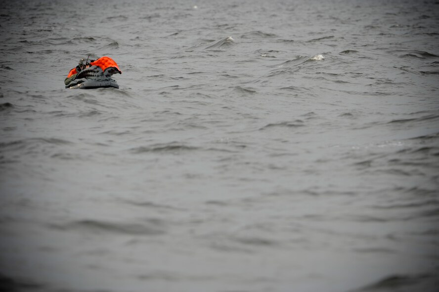 Airman 1st Class Taras Ivaniuk, 38th Rescue Squadron pararescueman from Moody Air Force Base, Ga., plays the role of a downed pilot during water rescue training in the Gulf of Mexico, Aug. 14, 2012. The exercise tested 347th Rescue Group members' ability to locate and rescue downed personnel in open water. (U.S. Air Force photo by Staff Sgt. Joshua J. Garcia/Released)
