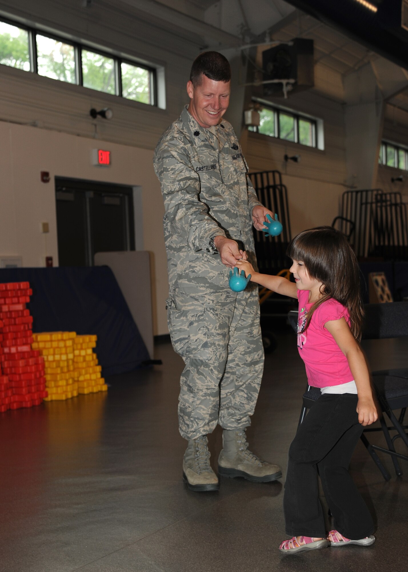Lt. Col. Jonathan Castellanos, 319th Wing Staff Agencies Commander, plays lawn darts with Micah Troyer, 3, at the Exceptional Family Member Program Family Event, Aug. 15, 2012, on Grand Forks Air Force Base, N. D. The event was held to raise awareness of the different opportunities that the EFMP offers. The mission of the EFMP is to improve the quality of life of families that support a family member with a special need. The event was made possible in part by a grant from the Air Force Aid Society. (U.S. Air Force photo/Airman 1st Class Ashley N. Taylor)