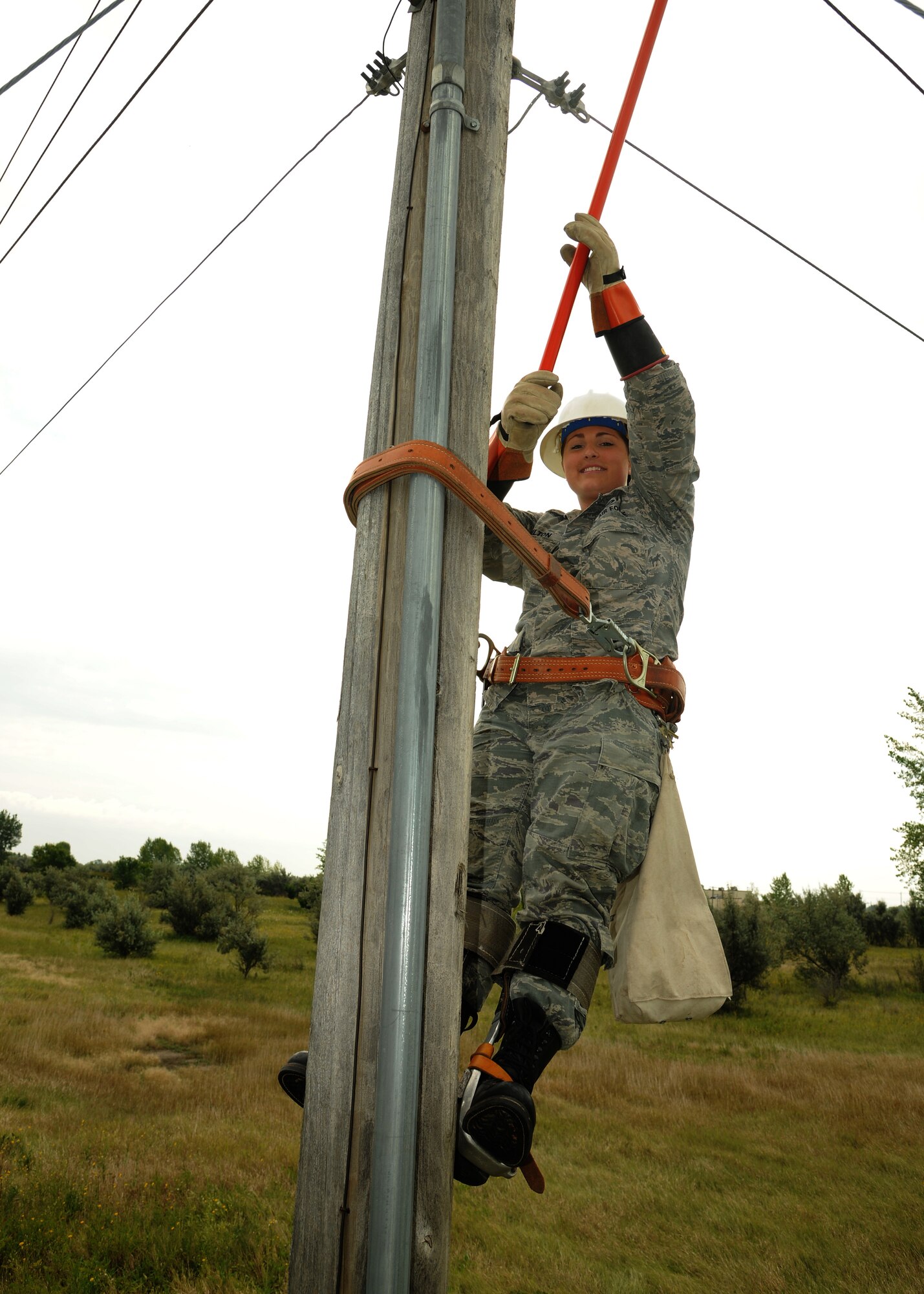 Airman Miranda Hamiliton, 319th Civil Engineer Squadron electrical apprentice, works to restore power to a base facility, Aug. 15, 2012, on Grand Forks Air Force Base, N. D.  The job of an electrical apprentice consists of maintaining the power for all base facilities, managing airfield lighting and maintaining base alarm systems.  (U.S. Air Force photo/Airman 1st Class Ashley N. Taylor)     