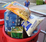 A Feds Feed Families food bank donation barrel overflows at a collection event held at the Air Force Personnel Center on Joint Base San Antonio-Randolph, Texas, Aug. 15. (U.S. Air Force photo by Rich McFadden) 