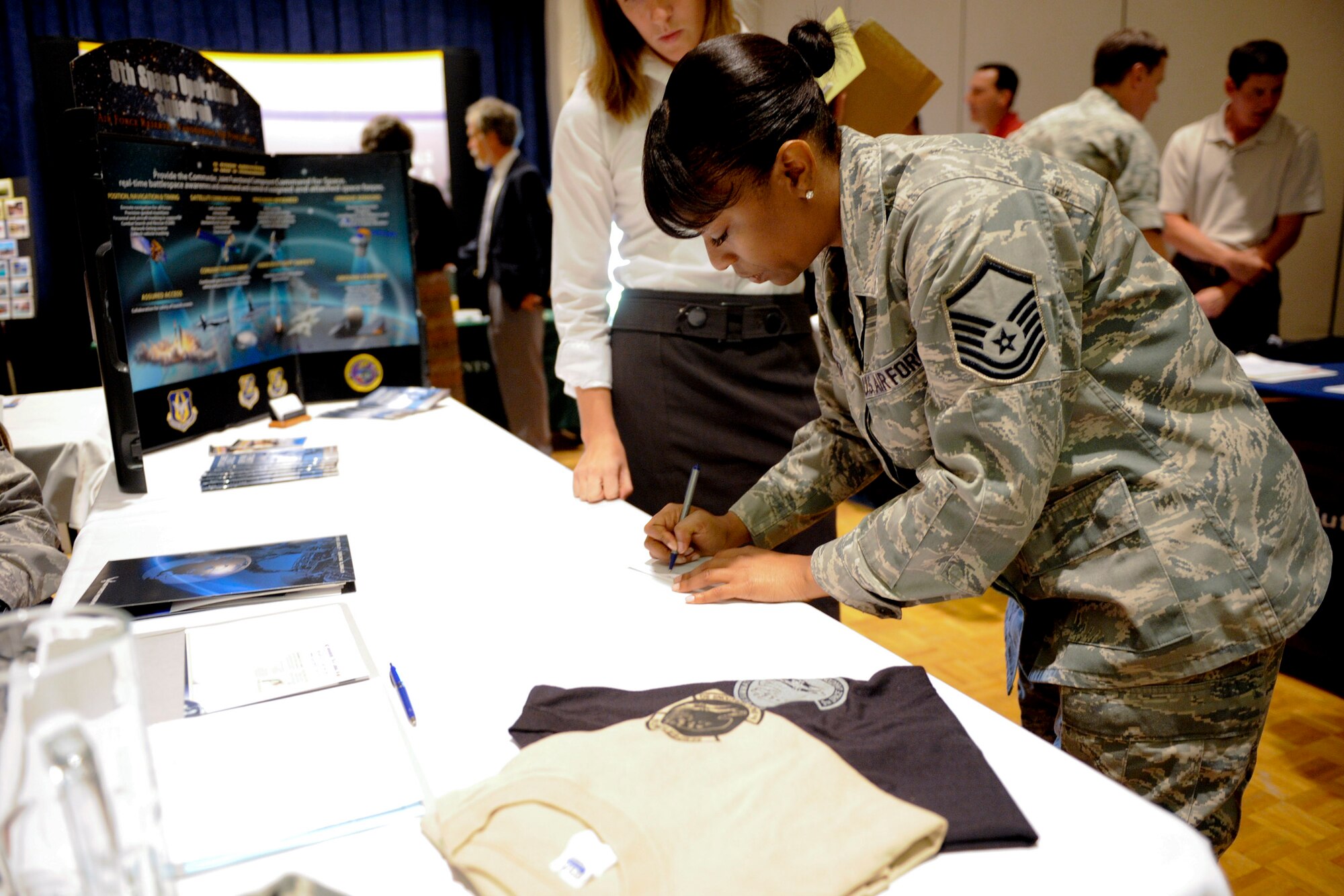 VANDENBERG AIR FORCE BASE, Calif. -- Master Sgt. Kamala Thigpen, an Air Force Reserve in service recruiter, writes information down for someone interested in joining the Air Force Reserves at the 2012 Vandenberg Job Fair at the Pacific Coast Club here Wednesday, August 15, 2012. The fair had 27 prospective employers and was open to Active Duty military, Reservist, National Guard, Department of Defense civilians, contractors, retirees and family members. (U.S. Air Force photo/Staff Sgt. Levi Riendeau)

