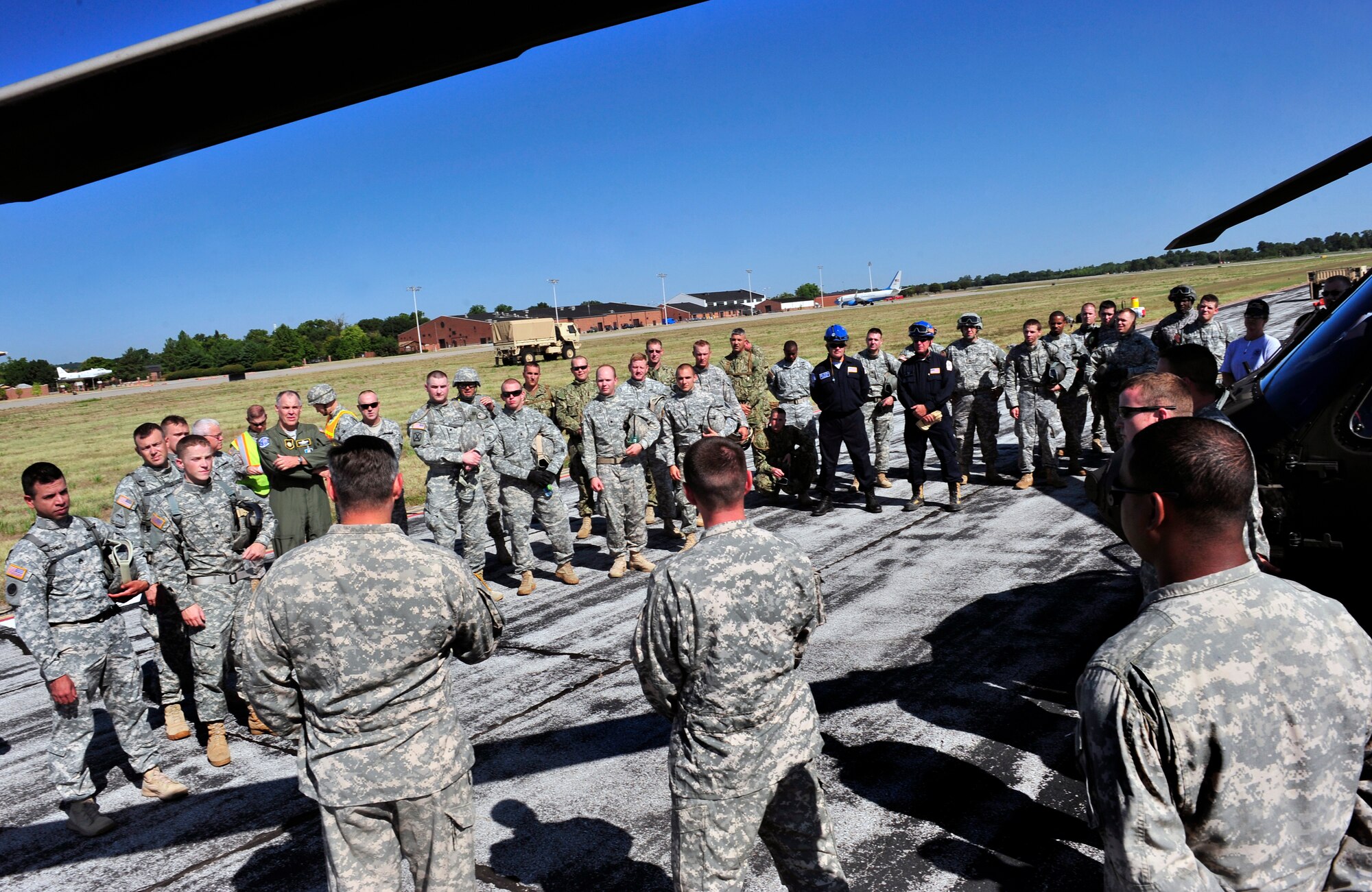 Members of the Illinois National Guard prepare to participate in sling load training on Scott Air Force Base, Ill. Aug. 11, 2012. The U.S. Transportation Command's Joint Transportation Reserve Unit, held this training for Air Force, Army, Navy and Department of Homeland Security personnel to learn about sling load and medical evacuation in the event of a natural disaster or emergency were to occur in this area. This is the first time the training has taken place on Scott. (U.S. Air Force photos/ Staff Sgt. Stephenie Wade)
