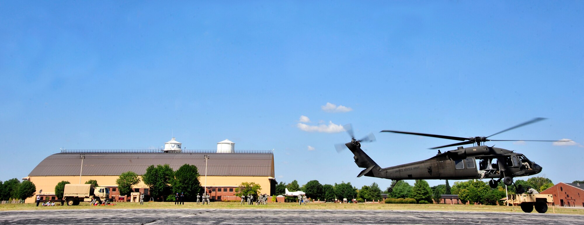 The Illinois National Guard uses a UH-60 Blackhawk helicopter to lift a sling loaded trailer during training on Scott Air Force Base, Ill. Aug. 11, 2012. The U.S. Transportation Command's Joint Transportation Reserve Unit, held this training for Air Force, Army, Navy and Department of Homeland Security personnel to learn about sling load and medical evacuation in the event of a natural disaster or emergency were to occur in this area. This is the first time the training has taken place on Scott. (U.S. Air Force photos/ Staff Sgt. Stephenie Wade) 