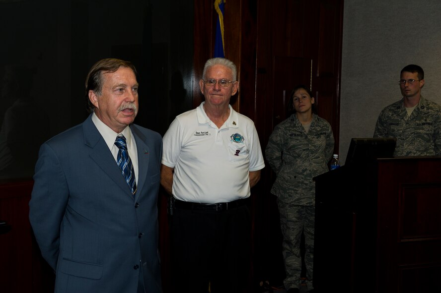Robert Cole, a commissioner of Santa Rosa County (left), speaks about his experience during a civic tour to Cannon Air Force Base, N.M., during a ceremony at 1st Special Operations Wing headquarters on Hurlburt Field, Fla., Aug. 15, 2012. The commissioners from Santa Rosa and Okaloosa Counties presented a new sister county proclamation plaque. (U.S. Air Force photo/Airman 1st Class Christopher Williams)