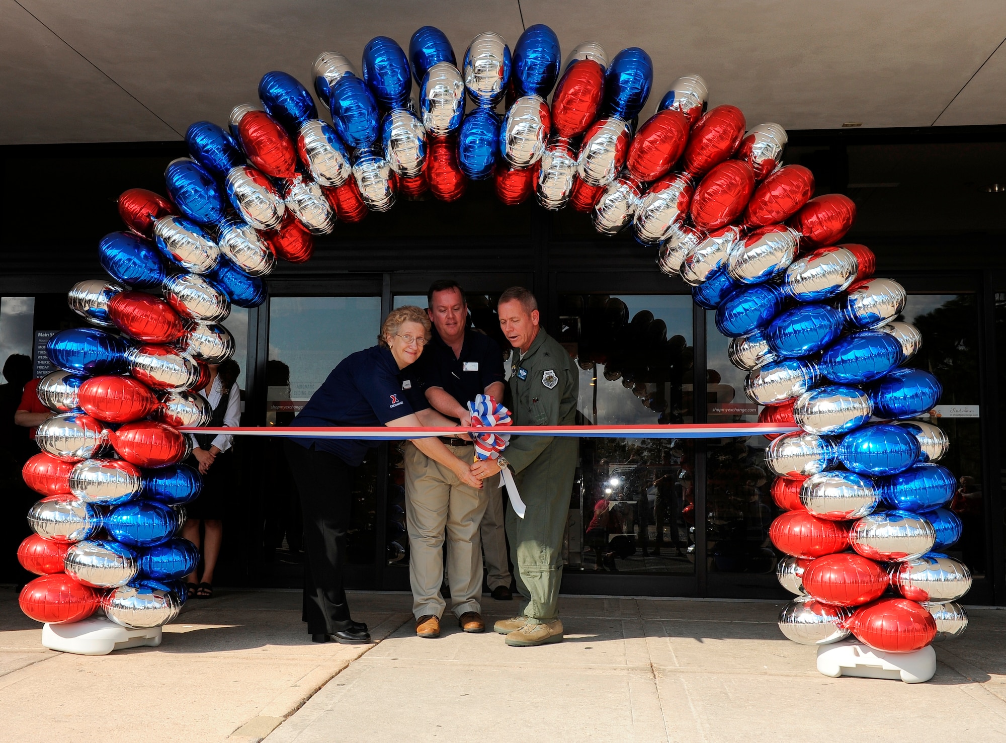 Ms. Lurlene Gordey, Base Exchange store manager, Mr. Phillip Capshaw, BX General Manager, and Brigadier Gen. John McMullen, 325th Fighter Wing commander, cut the ribbon at the newly renovated Tyndall Base Exchange Aug. 16. (U.S. Air Force photo by Lisa Norman)