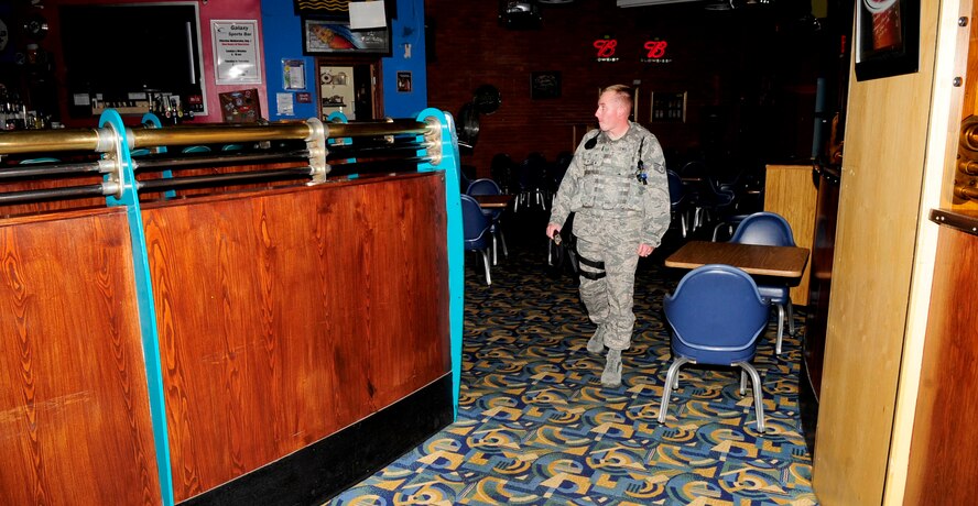 RAF MILDENHALL, England -- Staff Sgt. Benjamin Lewis, 100th Security Forces Squadron response force leader, performs a building walk-through of the Galaxy Club at RAF Mildenhall Aug. 15, 2012. Security forces Airmen perform multiple building walkthroughs during the day to ensure there is no suspicious activity or attempt at unauthorized entry to the building. (U.S. Air Force photo/Senior Airman Ethan Morgan)