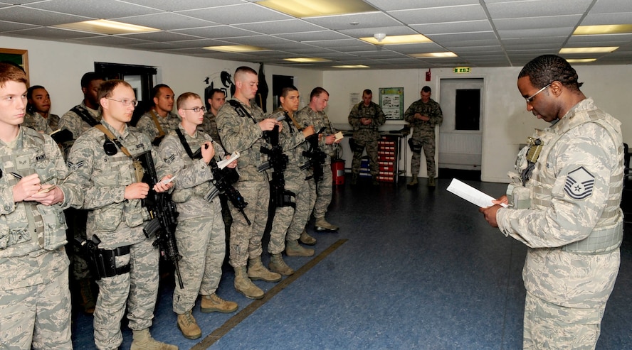 RAF MILDENHALL, England – Master Sgt. Varian Gibbs, 100th Security Forces Squadron flight chief, gives a guard mount brief to 100th SFS Airmen before they start their shift on RAF Mildenhall Aug. 15, 2012. The guard mount brief is performed to ensure accountability and pass along any information that may be relevant. (U.S. Air Force photo/Senior Airman Ethan Morgan)